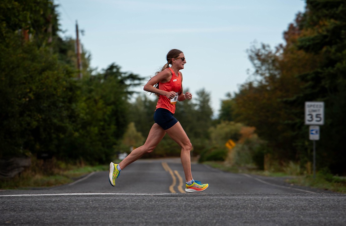 Courtney Olsen runs through an intersection on Country Lane. Olsen won the women's marathon with a time of 2:45:13.