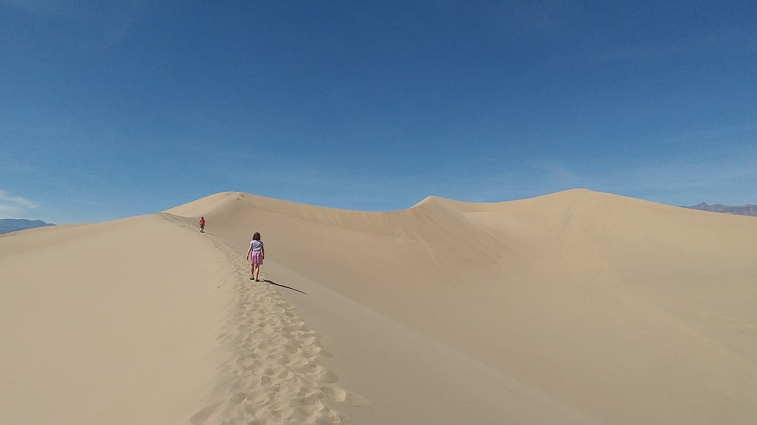 Holly and Caden Martin hike up a sand dune on April 4, 2017, in Death Valley National Park. Death Valley had several outhouses vandalized in the 2019 government shutdown.