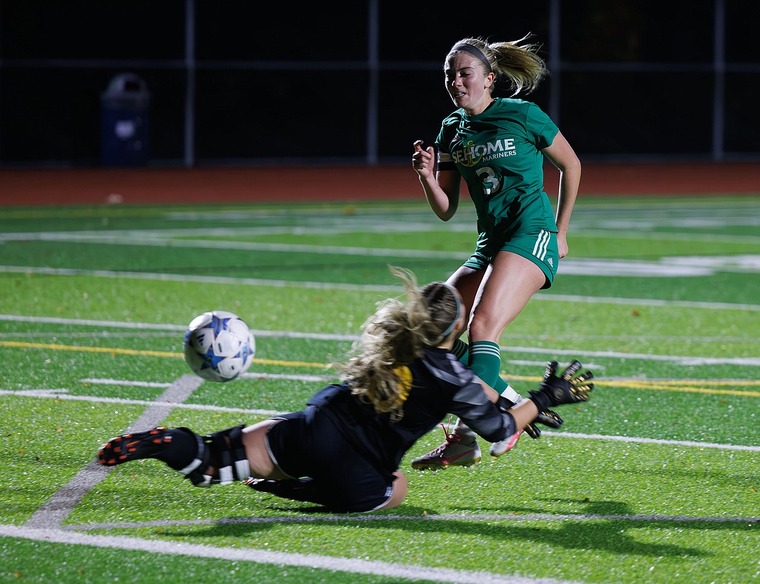 Sehome’s Ava Lontine kicks the ball past Ferndale’s Jaiden O’Neill for a goal as the two teams battled to a 2-2 tie game on Sunday, Oct. 3 in Bellingham.