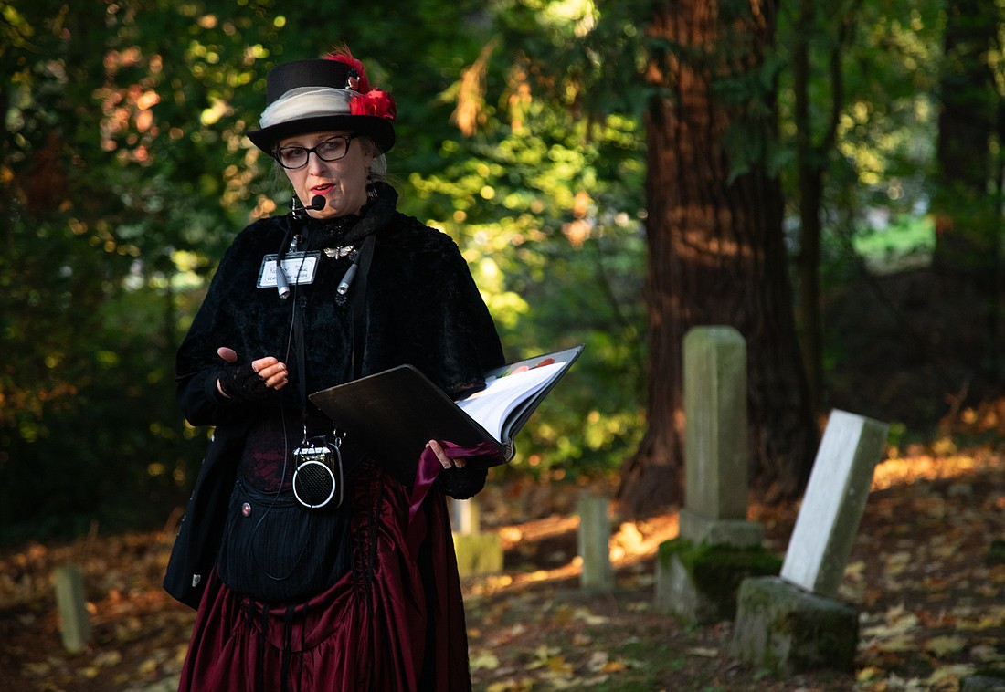 Kolby LaBree of the Good Time Girls tells the history of a gravesite during a Wednesday, Oct. 11 tour. While Buried Bellinghistory is now sold out for October, the Good Time Girls lead costumed “Gore and Lore” tours in downtown Bellingham and historic Fairhaven.