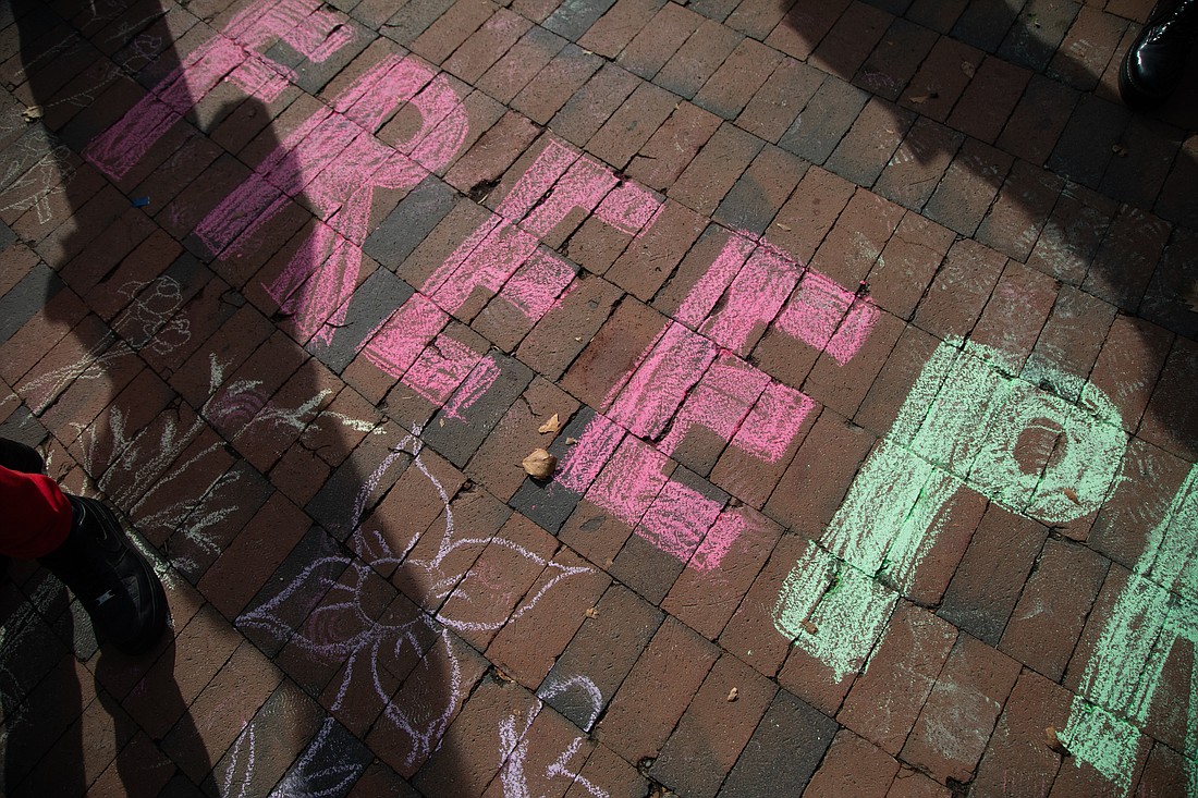 Western Washington University students wrote "Free Palestine" on the bricks in Red Square during a rally organized by the Arab Student Association on Friday, Oct. 13.