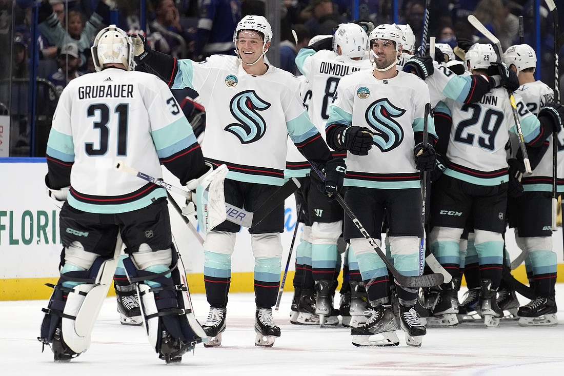 Seattle Kraken goaltender Philipp Grubauer (31) celebrates with teammates after the team defeated the takes a break during a stoppage in play against the during overtime in an NHL hockey game Monday, Oct. 30, 2023, in Tampa, Fla.