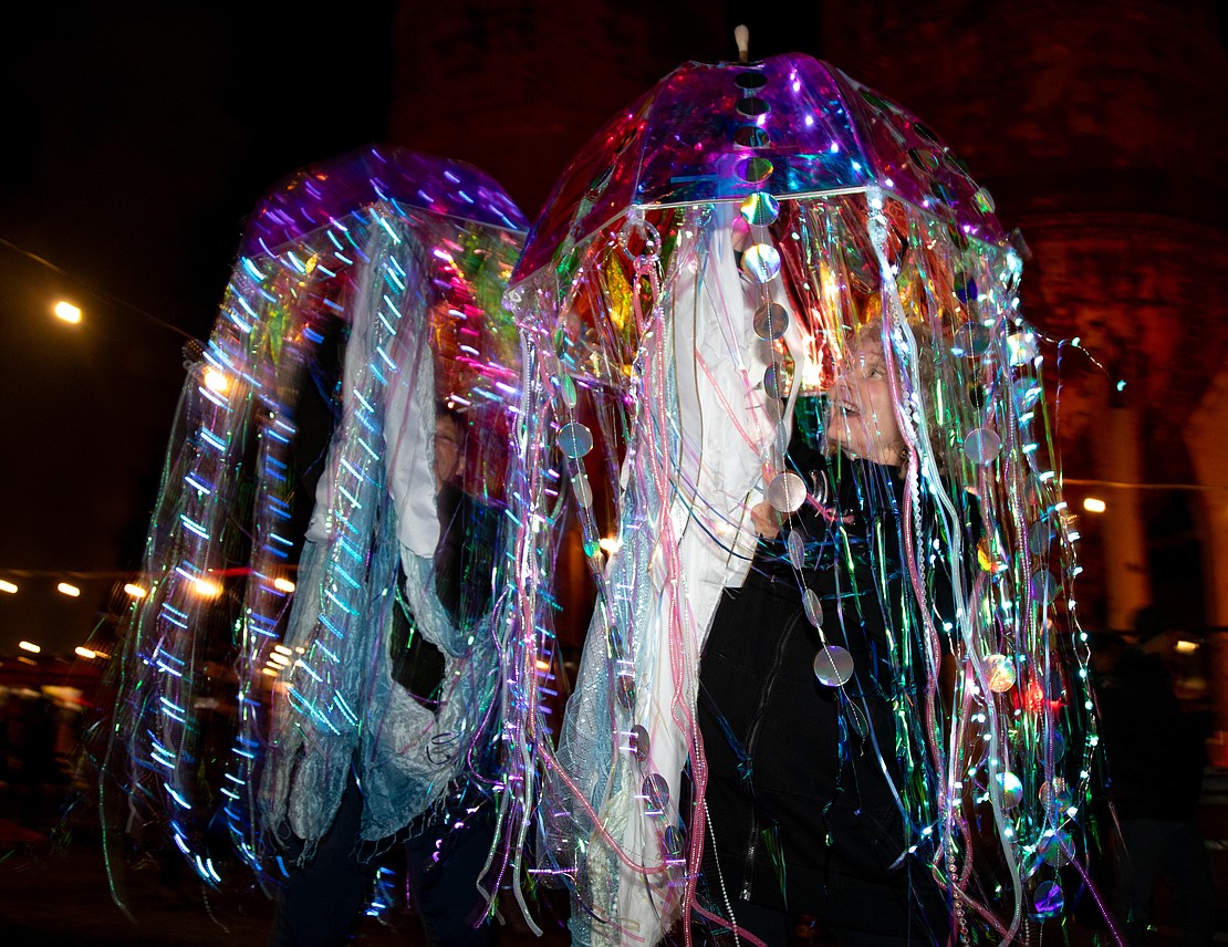 Deb, right, and Ed Speer open and close their sparkly jellyfish umbrellas.