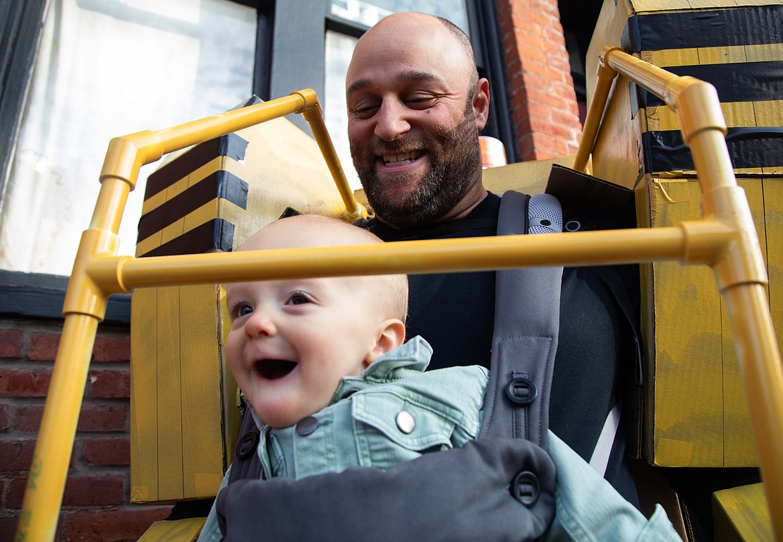 Dressed as Ripley and the Power Loader from the movie "Aliens," Jake Parks carries his son Olin Day-Parks through Fairhaven.