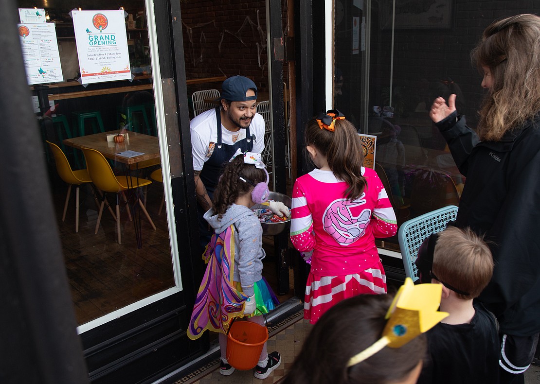 Justin Valle hands out candy from his new Puerto Rican restaurant, J's Kitchen, in Fairhaven.
