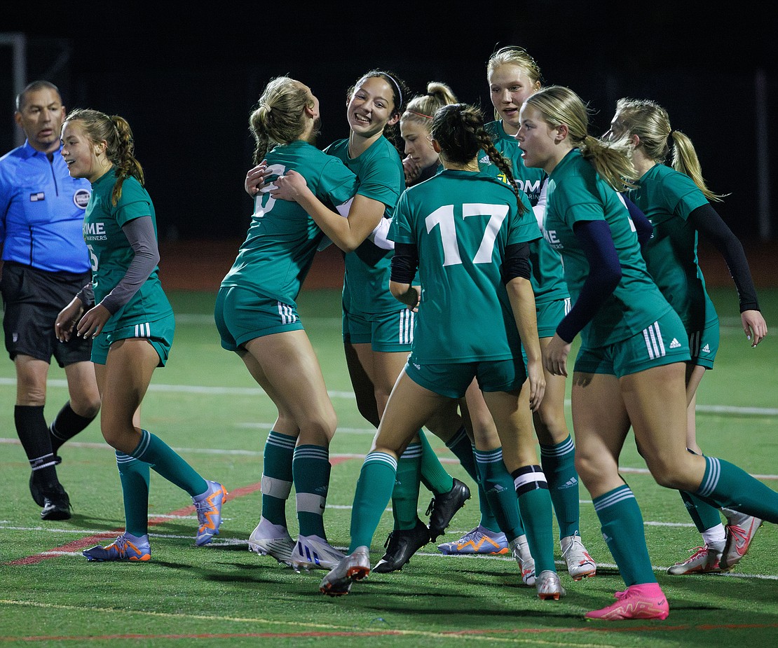 Sehome’s Keira Reeves, facing, is hugged by teammates after scoring the first goal of the game.
