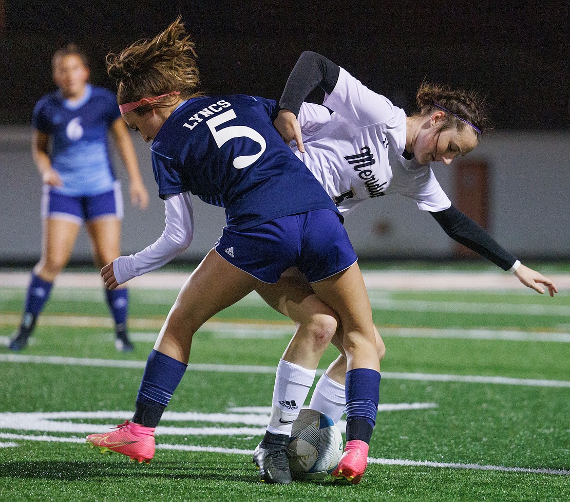 Lynden Christian's Nayla Speer and Meridian’s Erica Stotts battle for control of the ball in the first half.