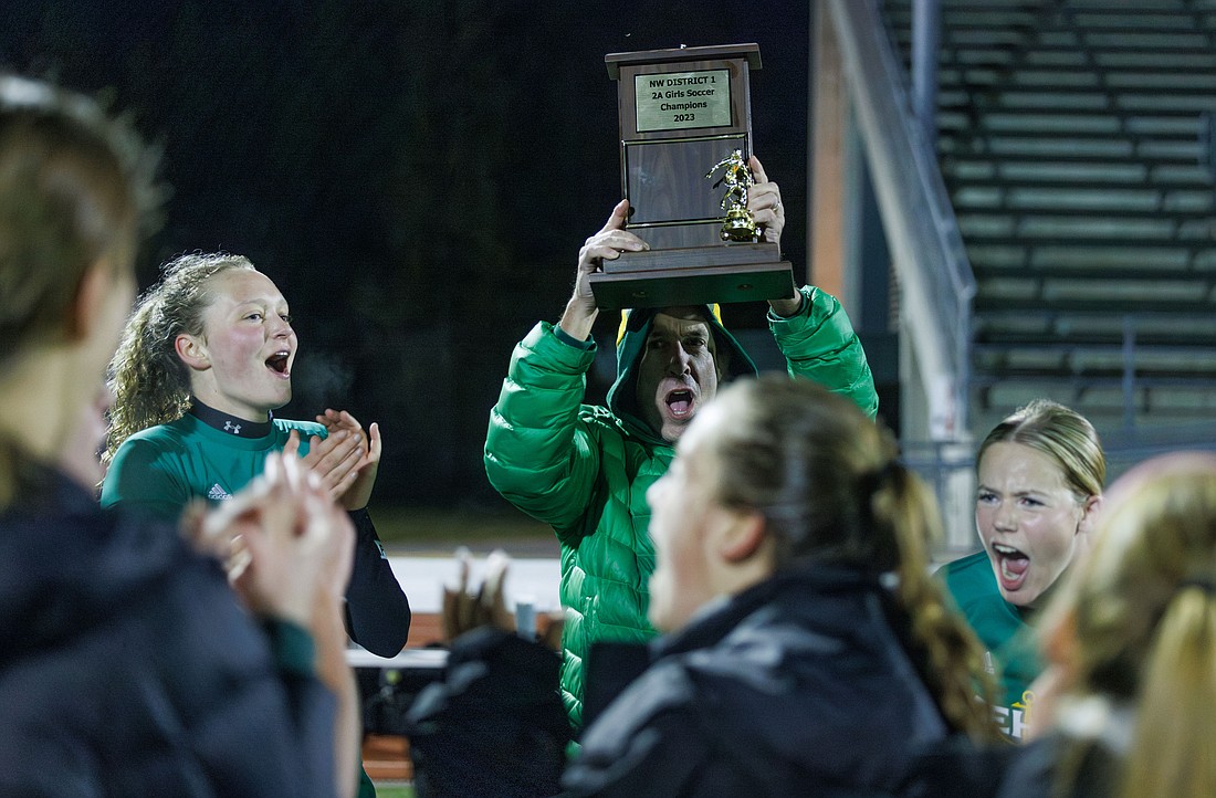 Sehome athletic director Colin Cushman celebrates the Mariners’ district championship with players Tuesday, Oct. 31 after beating Cedarcrest 4-1 in the 2A District 1 title game at Civic Stadium.