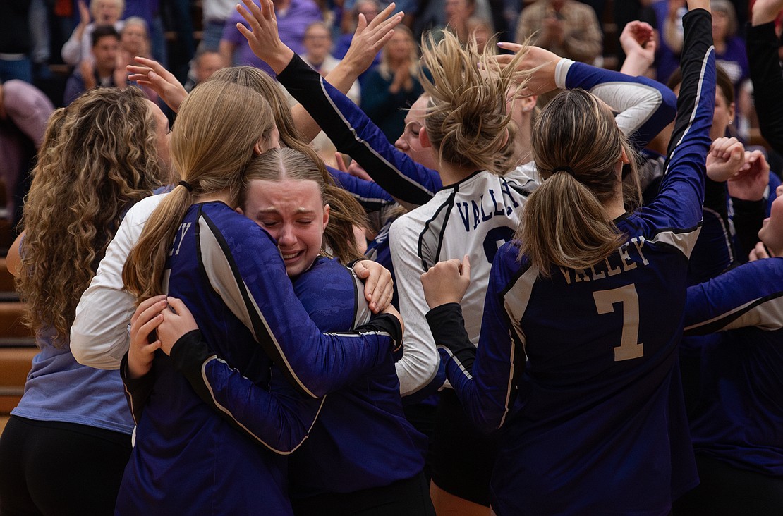 Nooksack Valley sophomore pin hitter Kaydin Thompsen, right, hugs freshman middle blocker Lily Lohrer as the team celebrates the win.