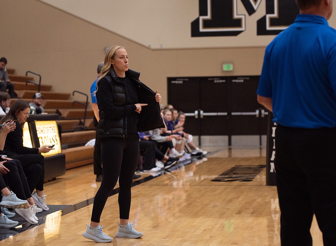 Lynden Christian head coach Kristy VanEgdom shields a serve call with her vest.