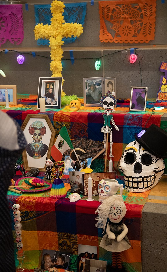 The altar for el Día de los Muertos features photos and notes honoring loved ones who've passed on.