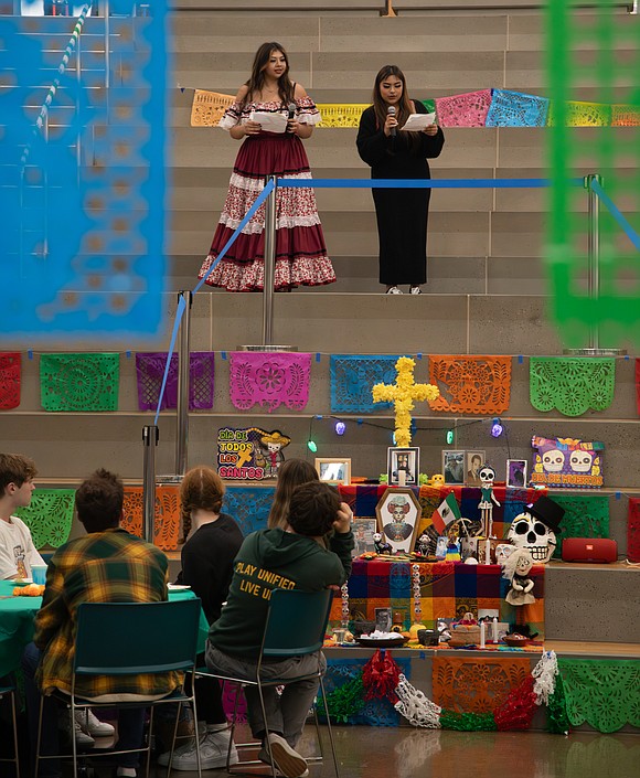 Seniors from the Latinx Club Analeigha Garza, left, and Nayeli Arreola welcome attendees to the celebration and give a land acknowledgement.