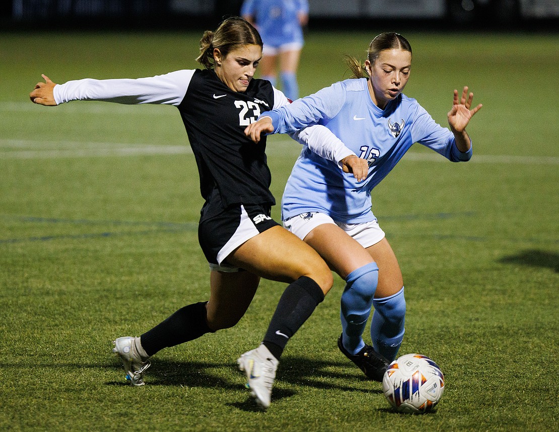 Western Washington University's Gracen Crosby and Seattle Pacific University’s Taylor Krueger battle for the ball.