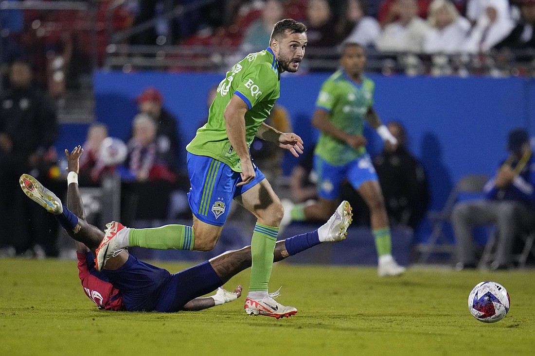 Seattle Sounders forward Jordan Morris, front, gets by FC Dallas defender Sebastien Ibeagha before scoring a goal during the second half in Game 2 of a first round MLS playoff soccer match, Saturday, Nov. 4, 2023, in Frisco, Texas.