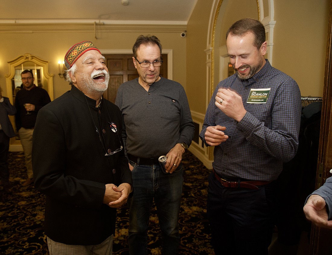 Whatcom County Executive incumbent Satpal Sidhu shares a laugh with Rud Browne and Jon Scanlon after preliminary results are announced. Sidhu leads his race with 57.9% of the votes as of Wednesday, Nov. 8.