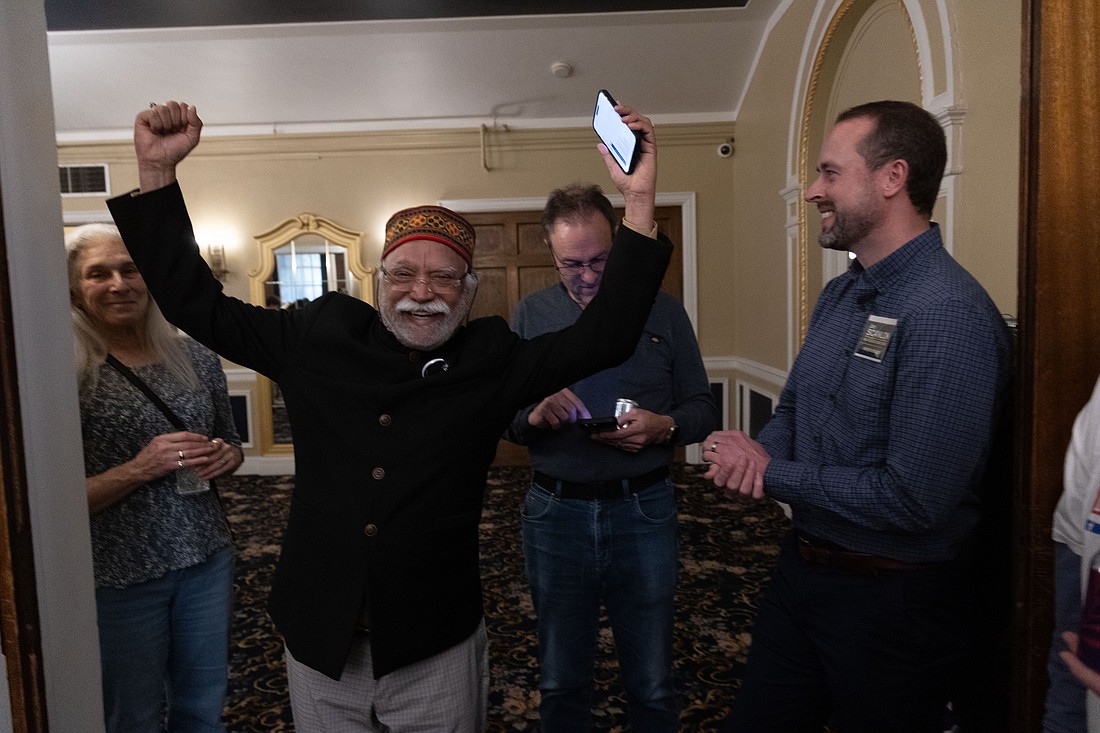 Whatcom County Executive incumbent Satpal Sidhu reacts as county council candidate Jon Scanlon looks on Tuesday, Nov. 7 at Hotel Leo in Bellingham. Sidhu received 55.68% of the votes in the preliminary count.