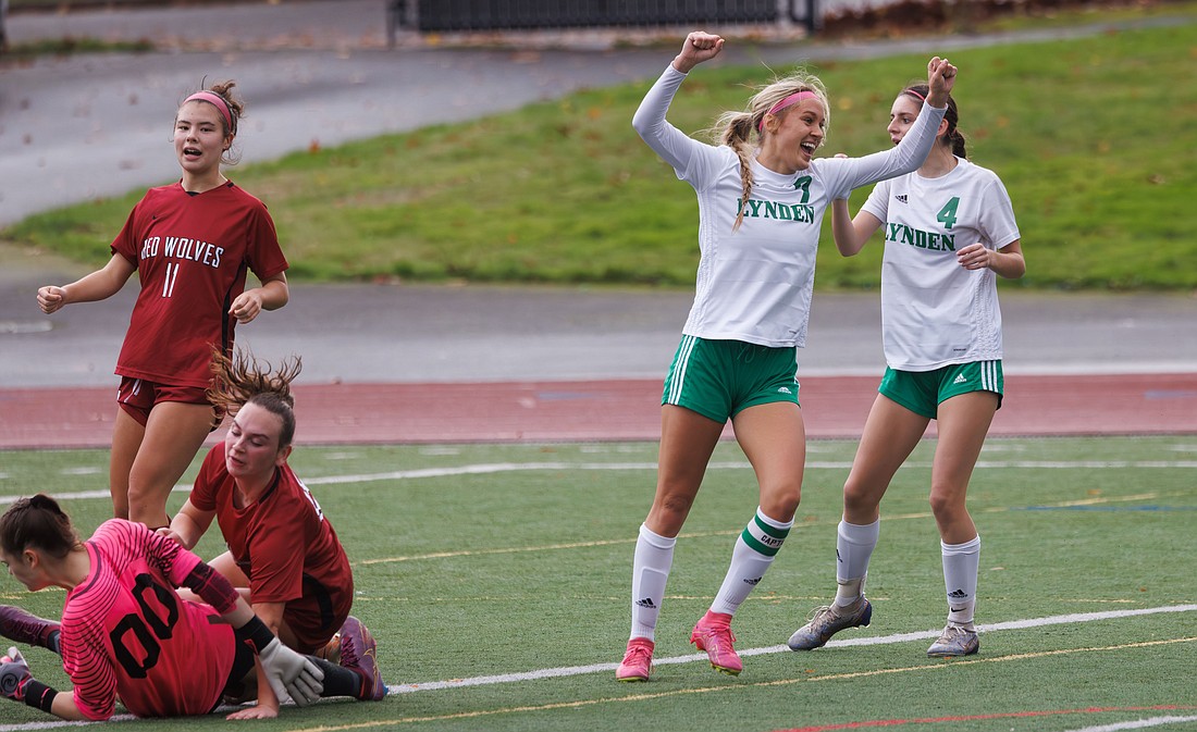 As Cedarcrest players collide, Lynden’s Mallary Villars celebrates her goal Saturday, Nov. 4 during the Lions' 2A District 1 consolation final victory. Lynden is headed back to the 2A state tournament after winning four straight matches in districts.