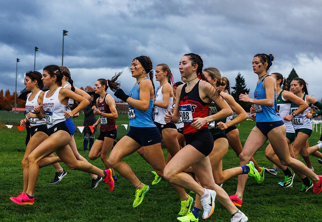 Western Washington University's Ila Davis, left, and Ashley Reeck run amid a pack of other women's athletes Saturday, Nov. 4 during the NCAA Division II West Regional meet in Monmouth, Oregon.