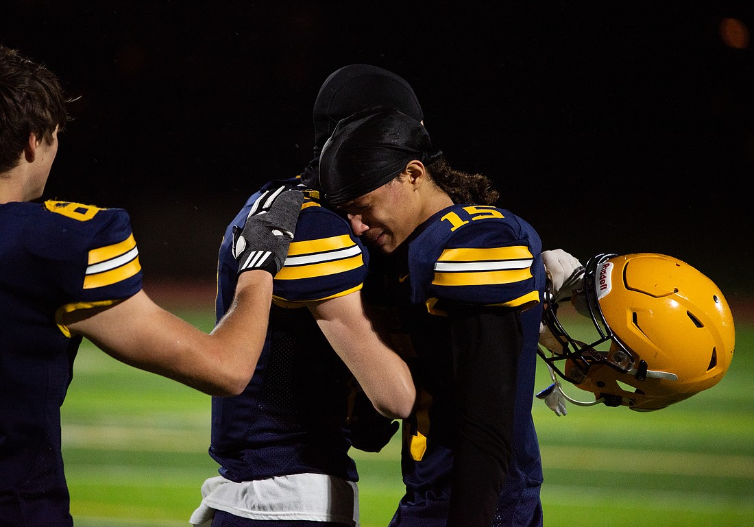 Ferndale senior wide receiver Kevin Woods, right, hugs junior receiver Hunter Wills after a home loss to Mount Tahoma in the first round of the 3A state tournament on Friday, Nov. 10.