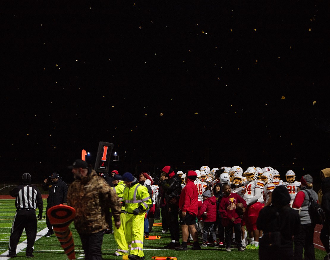 Leaves rain down on the field above the Mount Tahoma sideline during Friday's blustery game.