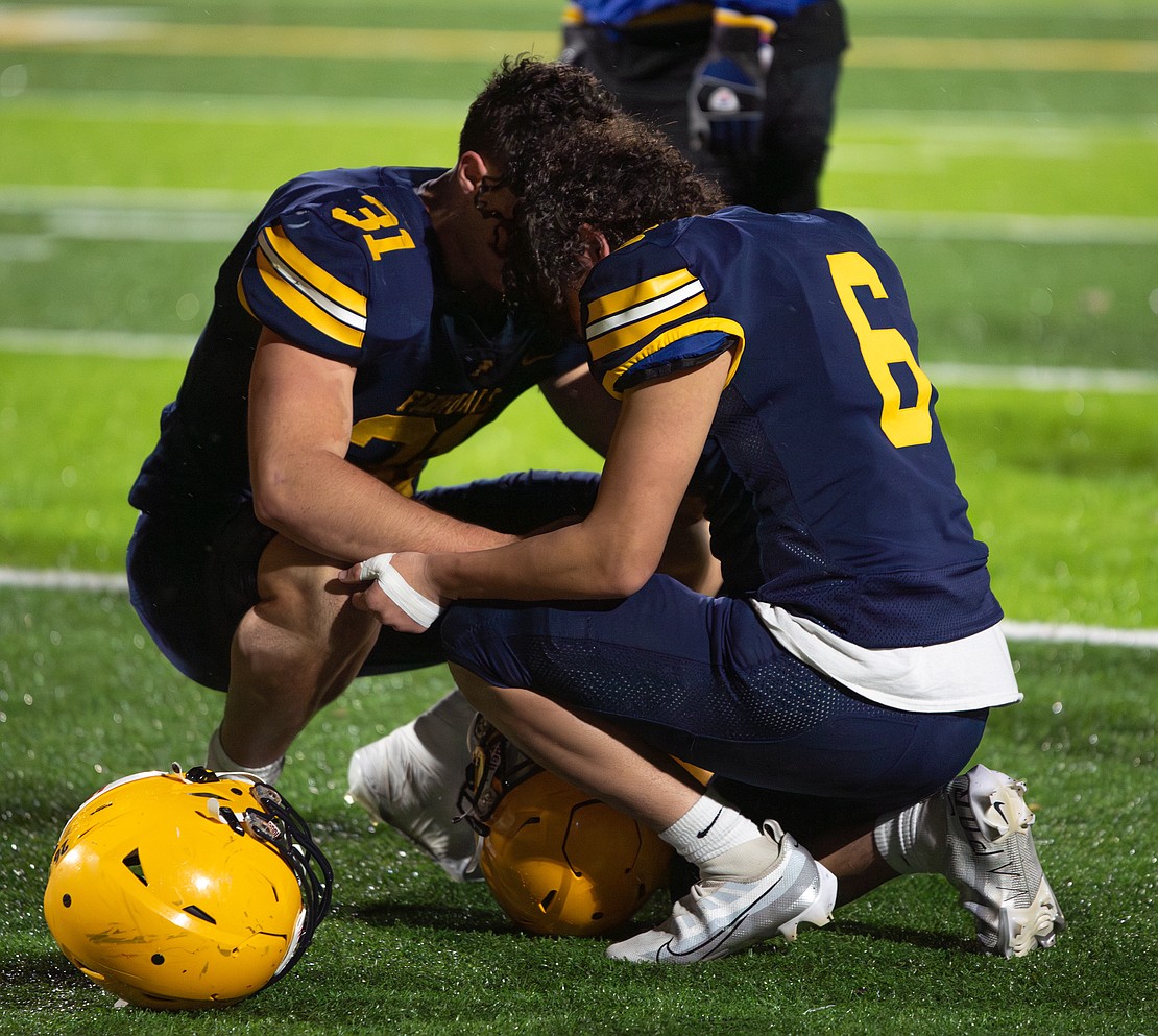 Ferndale junior running back Talan Bungard (31) and senior running back Kleaveland Atwood (6) share a moment after the game.