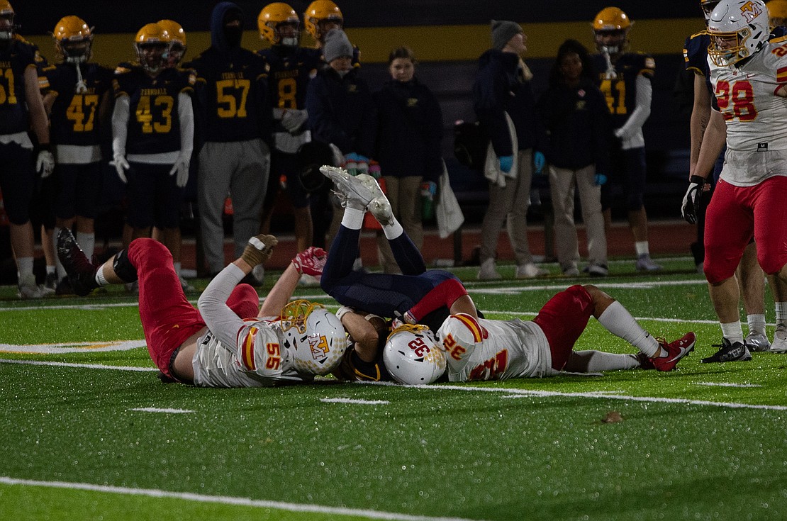 Mount Tahoma junior defensive end Malachi Neilsen (55) and sophomore free safety Joshua Durr (32) take down Ferndale senior quarterback Bishop Ootsey.