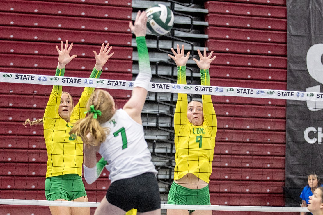Lynden's Grace Rice (8) and Finley Parcher (9) leap in an attempt to block a Tumwater shot.