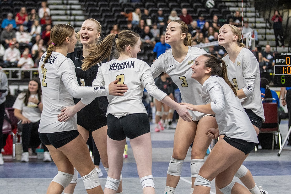 Meridian celebrates after scoring in the first set against Bellevue Christian.