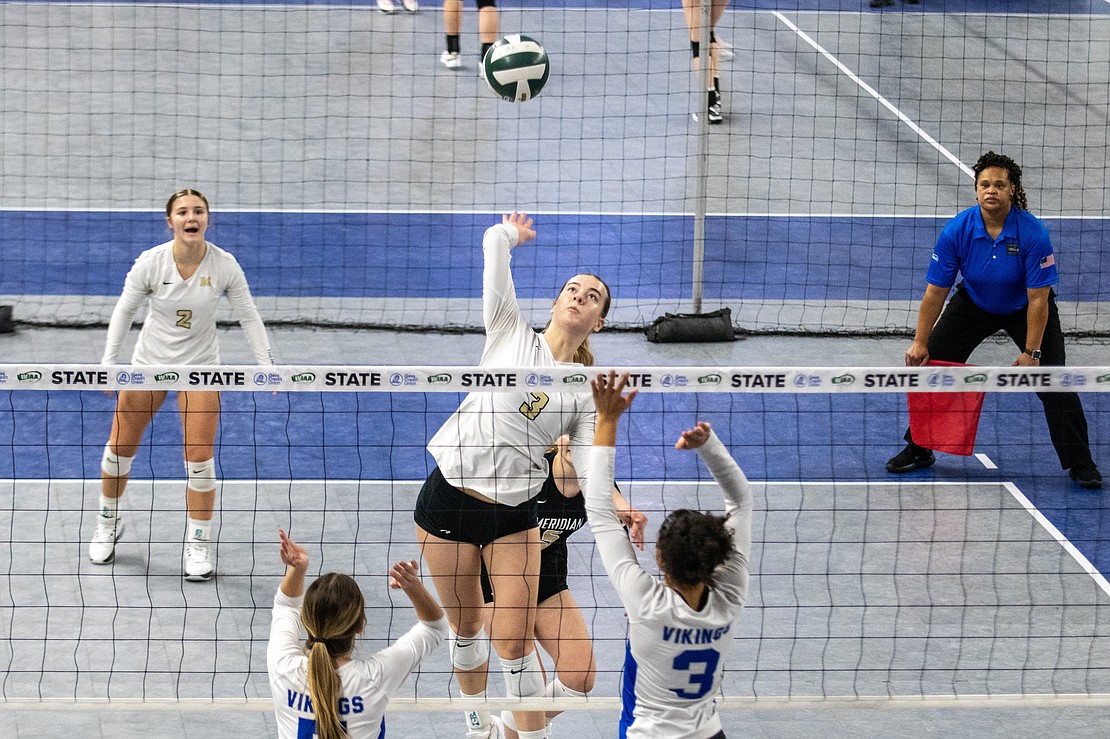 Meridian's Emry Claeys soars for a spike against Bellevue Christian.