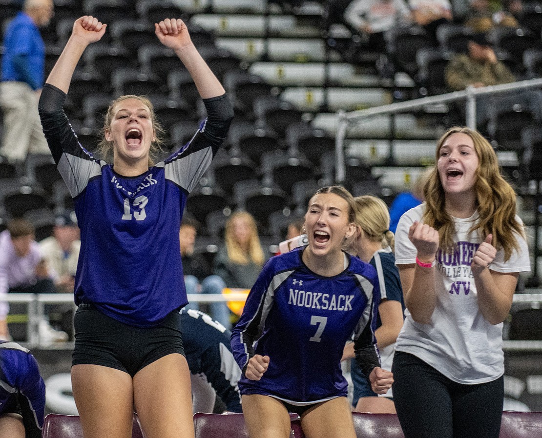 Nooksack Valley's Grace DeHoog (13) and Annie Stremler (7) celebrate a Pioneers point.