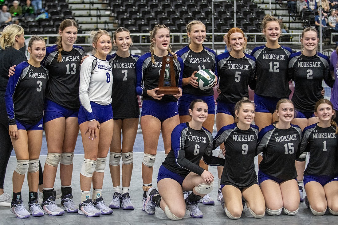 Nooksack Valley players pose with their sixth-place trophy Saturday, Nov. 11, after losing to Cedar Park Christian (Bothell) in five sets in the fifth/sixth-place match of the 1A state tournament.