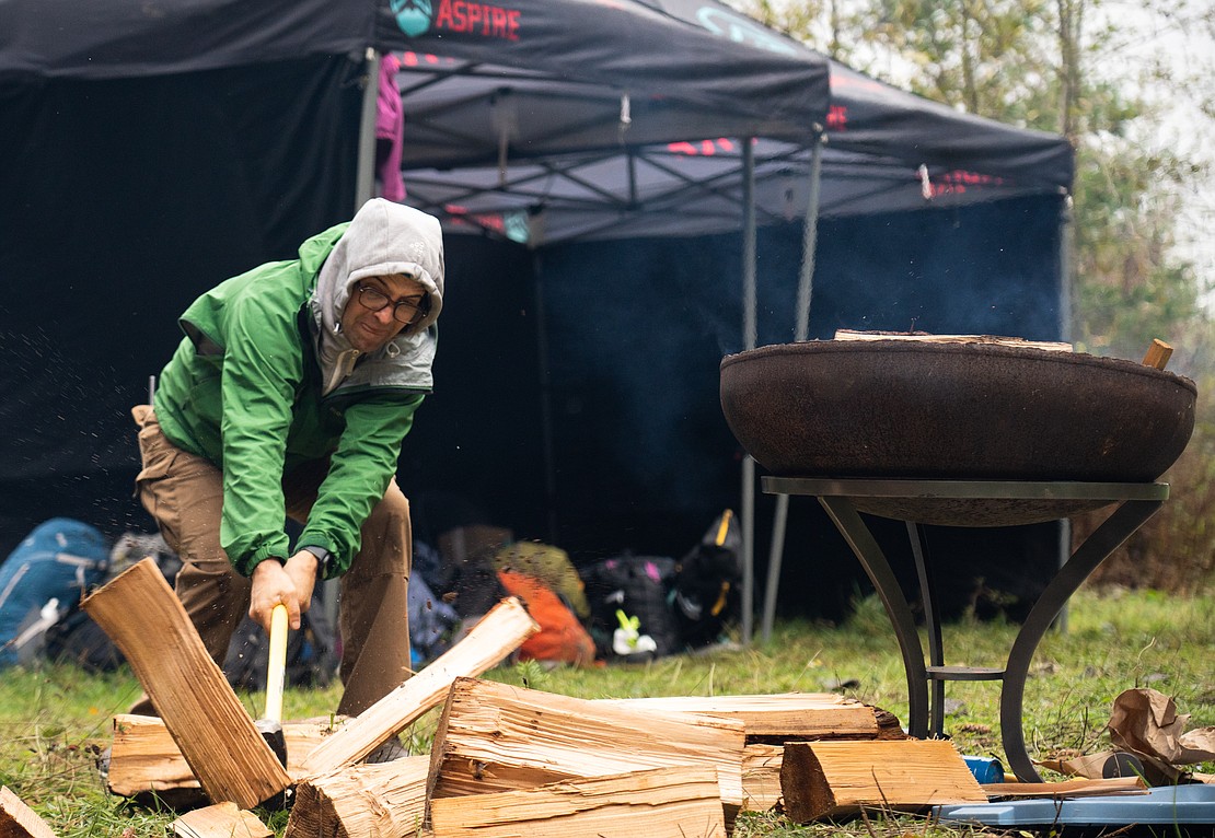 Race Director Abram Dickerson chops wood to keep the fire hot.