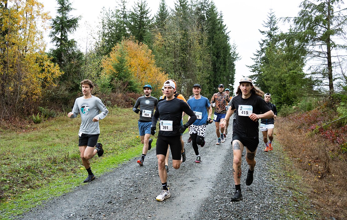 Kurtis Brumbaugh, front left, Spencer Paxton, back left, Jeff Malnick, front center, and Justin Daniels, front right, lead out the pack of runners racing the long course. The long course consisted of 13.5 miles and over 2,200 feet of elevation gain. Most racers missed turns and clocked even more distance and elevation than the course designated.