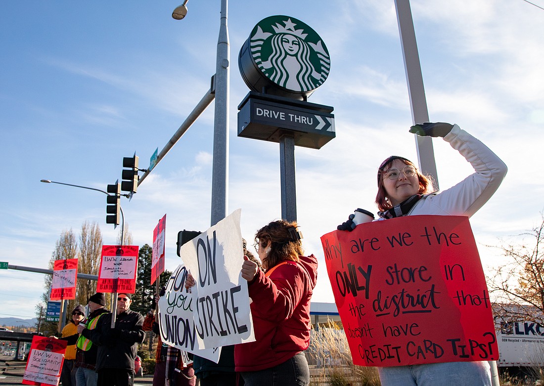 Supervisor Kelly Cabage, right, and other workers and supporters strike outside the Starbucks on Iowa Street on Thursday, Nov. 16, during the nationwide "Red Cup Rebellion" union effort.