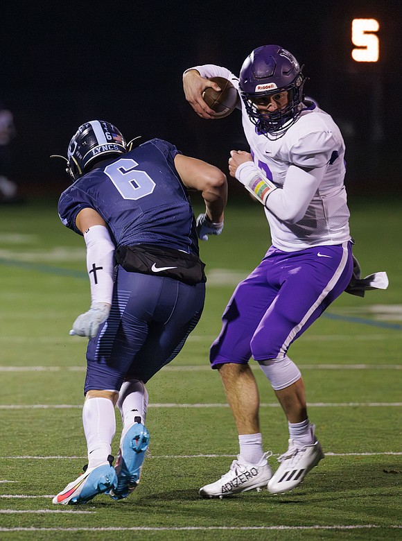 Nooksack Valley’s Joey Brown jukes a tackle attempt by Lynden Christian's Jeremiah Wright.