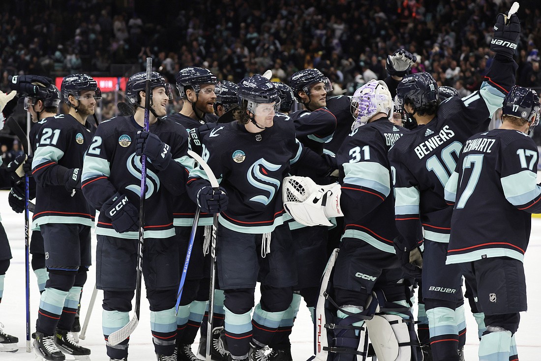 Seattle Kraken players celebrate the a shootout win over the the New York Islanders in an NHL hockey game, Thursday, Nov. 16, in Seattle.
