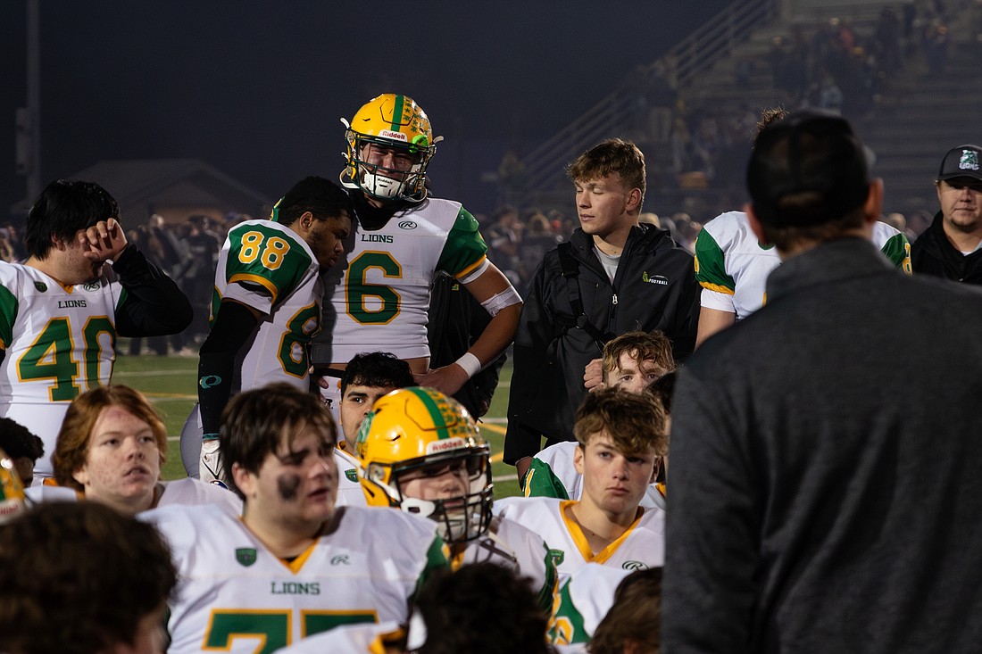 Lynden senior wide receiver Clay Wiesen (88) leans into junior quarterback Brant Heppner (6) Saturday, Nov. 18, while head coach Blake VanDalen delivers a post-game speech after losing to North Kitsap, 34-28, in the 2A state quarterfinals in Poulsbo.