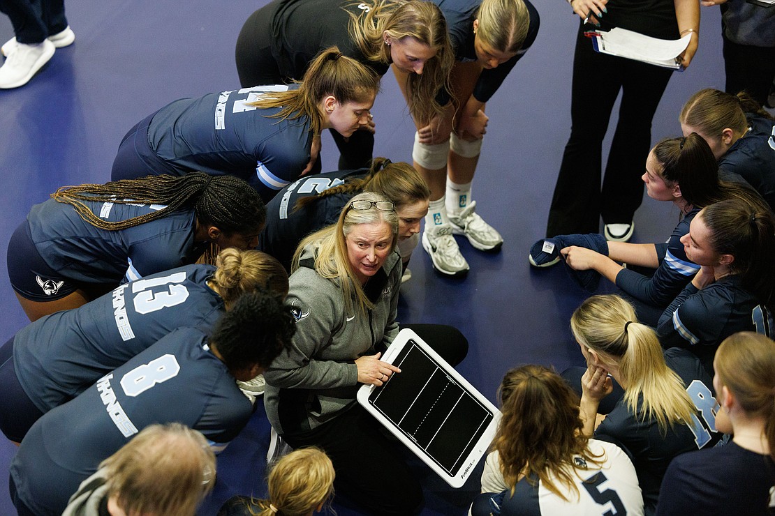 Western head coach Diane Flick-Williams talks with her team during a timeout while behind in the second set.