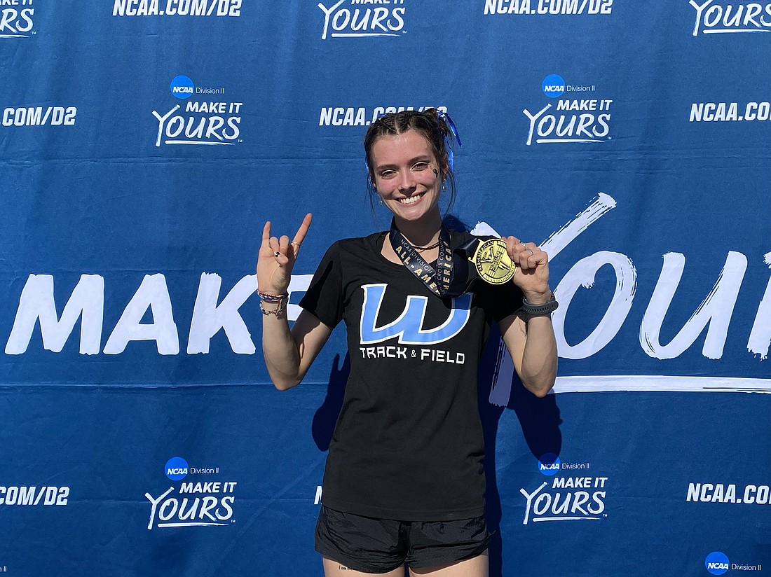 Western Washington University sophomore Ashley Reeck poses with her All-American medal Saturday, Nov. 18, after leading the Viking women to a 14th-place finish at the NCAA Division II National Cross Country Championships in Joplin, Missouri. Reeck was Western's top individual finisher, placing 30th overall.